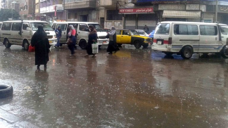 معلم بالإسكندرية يسلك بالوعات مدرسة من مياه الأمطار